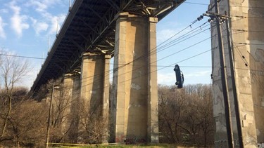 A Honda Civic hangs off the Millwood Bridge in Toronto on Wednesday, May 2, 2018.