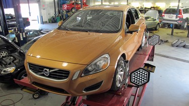 A Volvo S60 receives a wheel alignment at Volvo of Edmonton.
