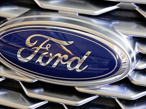 A Ford logo on the grill of a 2018 Ford Explorer on display at the Pittsburgh Auto Show.