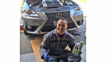 Toronto's William Ha does an oil change in the driveway of his home.
