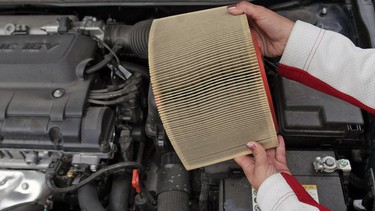 Former professional race car driver Kelly Williams holds a dirty air filter Monday, October 5, 2009. Williams hosts car care clinic across Canada.