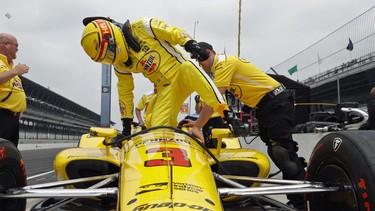 Helio Castroneves, of Brazil, climbs into his car during a practice session for the IndyCar Indianapolis 500 auto race at Indianapolis Motor Speedway, in Indianapolis Monday, May 21, 2018.