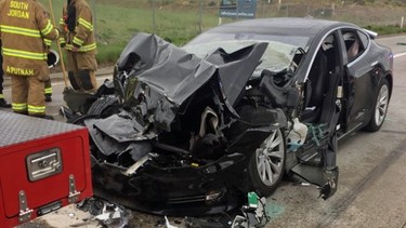 This Friday, May 11, 2018 photo released by the South Jordan Police Department shows a traffic collision involving a Tesla Model S sedan with a Fire Department mechanic truck stopped at a red light in South Jordan, Utah.