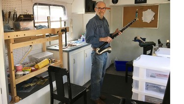 An accomplished musician and engineer—and carnut— Daryl Caswell pauses with a woodwind instrument in for repair.