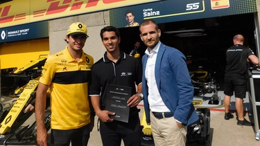 Renault Sport F1 driver Carlos Sainz (left) and Infiniti Global Motorsport Director Tomasso Volpe flank Chase Pelletier in the Renault pits on the Thursday of the 2018 Canadian Grand Prix weekend in Montreal.