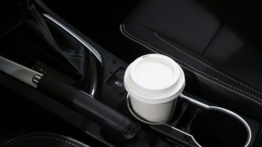 A coffee cup in the cupholder of a 2018 Toyota Corolla.