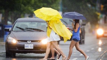 In this file photo, umbrellas provide some rain protection along Lakeshore Blvd. in Etobicoke on July 9, 2010.