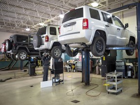Several Jeeps on stands in the service department at Go Dodge Don Mills. Toronto, Ont., June 9, 2018.