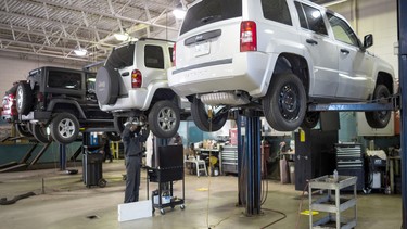 Several Jeeps on stands in the service department at Go Dodge Don Mills. Toronto, Ont., June 9, 2018.