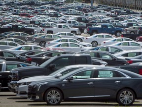 Vehicles are seen in a parking lot at the General Motors Oshawa Assembly Plant in Oshawa, Ont., on June 20, 2018.