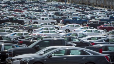 Vehicles are seen in a parking lot at the General Motors Oshawa Assembly Plant in Oshawa, Ont., on June 20, 2018.