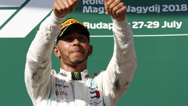 Mercedes driver Lewis Hamilton of Britain celebrates on the podium after winning the Hungarian Formula One Grand Prix, at the Hungaroring racetrack in Mogyorod, northeast of Budapest, Sunday, July 29, 2018.