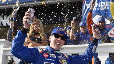 Kyle Busch celebrates in Victory Lane after winning a NASCAR Cup Series auto race, Sunday, July 29, 2018, in Long Pond, Pa.