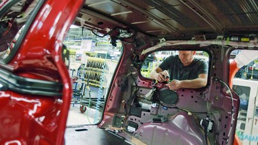 A production line worker assembles a Chrysler plant in Windsor, Ont. on January 18, 2011.