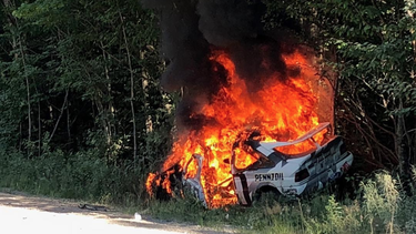 Ken Block's Ford Escort RS Cosworth goes up in flames after a crash at the New England Forest Rally.