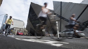 Cyclists take advantage of the bike lane along Bloor Street West in Toronto, just outside of the Royal Ontario Museum.