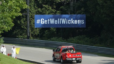BOWMANVILLE, ON - AUGUST 25: A sign wishing for the recovery of Canadian driver Robert Wickens who suffered serious injuries in a violent crash earlier this year is displayed at the start of the Mario Andretti Straightaway at Canadian Tire Mosport Park on August 25, 2018 in Bowmanville, Canada.