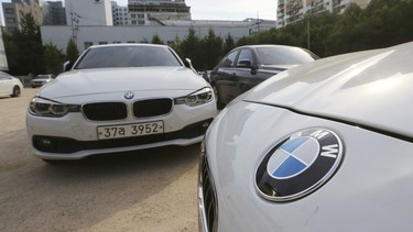 BMW cars are parked for an emergency safety check at the playground of an elementary school near a BMW service center in Seoul, South Korea, Tuesday, Aug. 14, 2018. South Korea will ban driving recalled BMWs that haven't received safety checks following dozens of fires the German automaker has blamed on a faulty exhaust gas component.