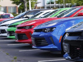 In this Wednesday, April 26, 2017, photo, Chevrolet Camaro sports cars are lined up in the lot of a Chevrolet dealership in Richmond, Virginia.