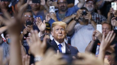 President Donald Trump waves to the cheering crowd as he arrives for a rally, Thursday, Aug. 2, 2018, at Mohegan Sun Arena at Casey Plaza in Wilkes Barre, Pa.