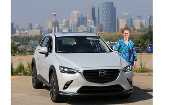 Gillian Macartney stands with the 2018 Mazda CX3 she test drove in and around Calgary.