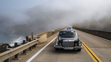 A classic Benz crosses the Bixby Creek Bridge, which was built in 1932 and is one of the most famous bridges in North America.