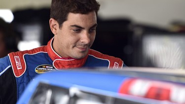 Stewart Friesen looks over his car during practice for Saturday's NASCAR Truck Series auto race, Friday, July 27, 2018, in Long Pond, Pa. Canada's Stewart Friesen has made big strides since adding full-time racing duties in the NASCAR Camping World Truck Series to his already busy calendar. His next stop on the circuit will be a playoff race in his home country.