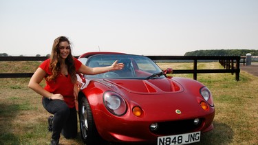 Elisa Artioli kneels besides the second-ever Lotus Elise in this 2018 photo. The sports car was named after her by her father, then owner of the company.