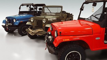 Vintage and new Mahindra Roxor trucks.