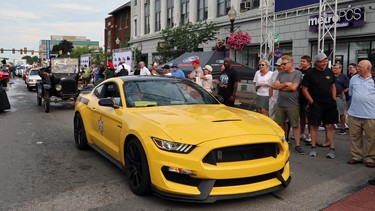 A Mustang leads a parade of police and fire vehicles to officially open the Woodward Dream Cruise.