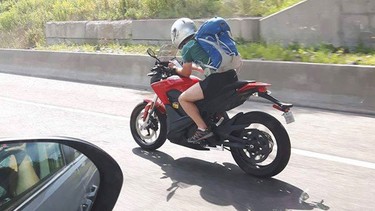 A viral image of a man texting while driving a motorcycle on a Quebec highway.
