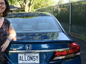 Vickie Louwet stands next to her ALL0NSY licence plate, which is among the first to be released in Quebec.