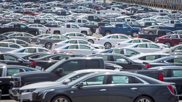 Vehicles are seen in a parking lot at the General Motors Oshawa Assembly Plant in Oshawa, Ont., on June 20, 2018.