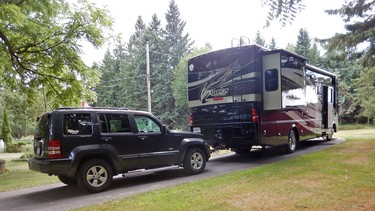 A motorhome with a 'dinghy' towed Jeep.