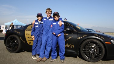 Super kids Amir Moghadfam, Daniel DeLeo and Diego Ibanez strike a pose by an Audi R8 during the second annual Aidan's Cup at Pitt Meadows airport last Saturday afternoon.