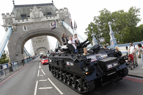 A file picture taken on September 1, 2008 in London shows British motoring programme Top Gear's presenters Jeremy Clarkson (L), James May (C) and Richard Hammond crossing Tower Bridge in a tank