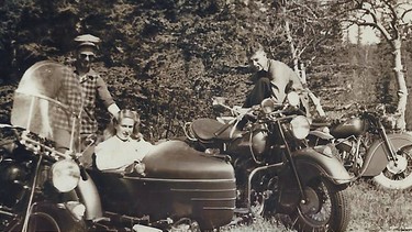 A trio of Indian Chief motorcycles, the middle with sidecar attached, out in the woods near Calgary. The image is from an album that documents the history of the original Ace-Hy Motorcycle Club of Calgary, and was marked on the back, ‘Weekend camping.’