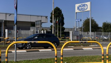 A picture taken on October 22, 2018 in Corbetta, west of Milan, shows the entrance to the headquarters of the Italian multinational company Magneti Marelli, specialized in the supply of high technology products and systems for the automotive industry. - Fiat Chrysler Automobile announced on October 22,2018 the sale of its equipment manufacturer Magneti Marelli to the Japanese group Calsonic Kansein, owned by the US investment fund KKR. The euro 6.2 billion transaction is expected to close early in 2019.