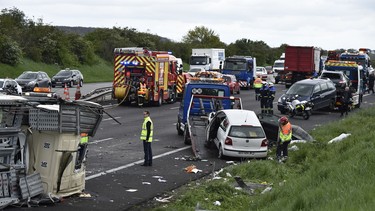 In this file photo, French rescue workers and police officers intervene on the site of a road accident on April 25, 2016 between two trucks and six other vehicles near Les Mureaux on the A13 motorway heading towards Paris, which caused at least two seriously injured. A recent mock trial, set in 2041, examines an issue similar to this — but involving autonomous cars.