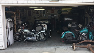 He’s packed a lot of goodies into his 24-foot by 24-foot Edmonton garage, and Patrick McTague has some other parts and projects stored off-site, too. In this image, his ‘swap meet’ special Harley-Davidson chopper on the left with his 1930 Ford Model A Coupe hot rod behind it. On the right, an original 1942 Harley-Davidson Knucklehead with his 1932 Ford Tudor Sedan behind it.