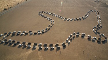 A parade of 180 Nissan Patrols forms a bird-shape for the world record for dancing cars, in 2018.