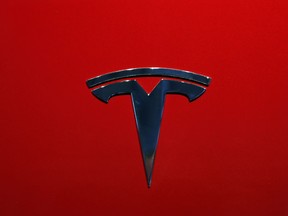 FILE- This Oct. 3, 2018, file photo shows the logo of Tesla Model 3 at the Auto show in Paris. U.S. securities investigators have subpoenaed information from Tesla about production forecasts for the Model 3 electric car that were made last year, the company acknowledged in a regulatory filing Friday, Nov. 2. The disclosure in Tesla’s quarterly financial report also says the Securities and Exchange Commission subpoena covered other public statements made about Model 3 production. The filing also says Tesla is cooperating with a Justice Department request for information about production.