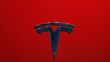 FILE- This Oct. 3, 2018, file photo shows the logo of Tesla Model 3 at the Auto show in Paris. U.S. securities investigators have subpoenaed information from Tesla about production forecasts for the Model 3 electric car that were made last year, the company acknowledged in a regulatory filing Friday, Nov. 2. The disclosure in Tesla’s quarterly financial report also says the Securities and Exchange Commission subpoena covered other public statements made about Model 3 production. The filing also says Tesla is cooperating with a Justice Department request for information about production.