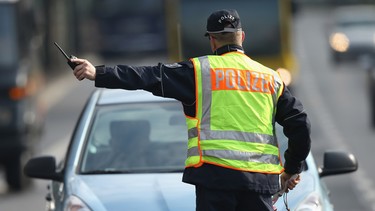 A policeman in Berlin pulls over a car caught speeding during a city-wide police action to catch people for speeding and other traffic infringements on April 16, 2013.