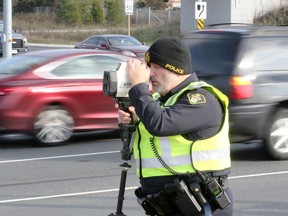 OPP Const. Mike Atkinson watches for speeding vehicles during traffic enforcement patrol in Windsor, Ontario November 14, 2017.