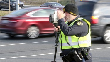 OPP Const. Mike Atkinson watches for speeding vehicles during traffic enforcement patrol in Windsor, Ontario November 14, 2017.