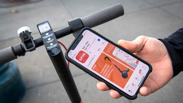 A person displays the Skinny Labs Inc. SpinBike shared electric scooter application on a Apple Inc. iPhone X in San Francisco, California, U.S., on Friday, April 13, 2018.