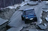 A Jeep CJ-7 in Alaska crossing an earthquake-ravaged pass of highway.