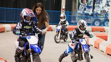 Jennifer Martin of the Yamaha Riding Academy gives advice to children experiencing their first ride aboard a motorcycle. At the Calgary Motorcycle Show at the BMO Centre at Stampede Park from Jan. 4 to 6, the Yamaha Riding Academy will be set up for the duration.