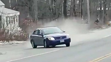 A 2007 Chevy Cobalt skids toward onlookers after hitting a police spike strip in December 2018 in Maine
